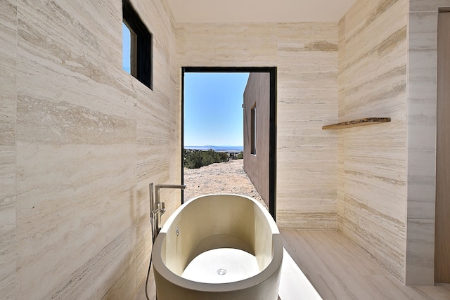 bathroom featuring a soaking tub