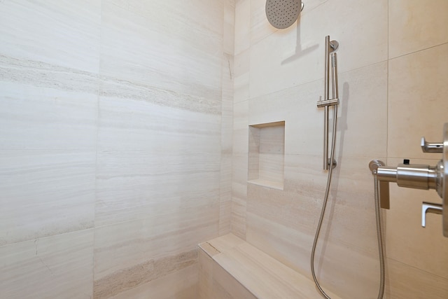 full bath featuring a tile shower