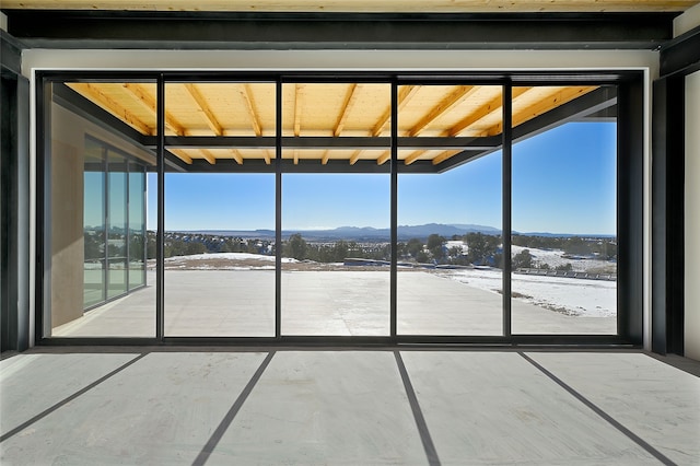 unfurnished sunroom with a mountain view