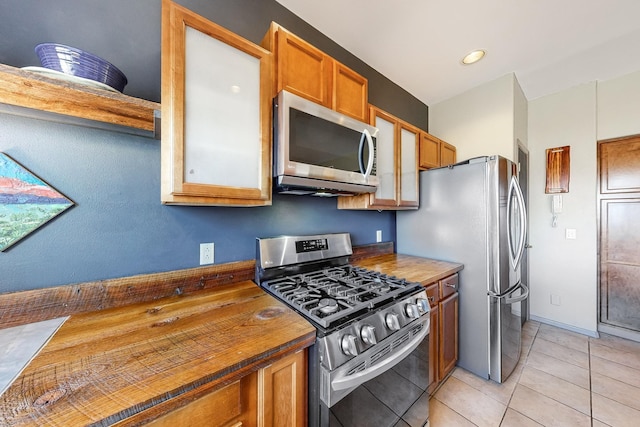 kitchen with light tile patterned floors and appliances with stainless steel finishes