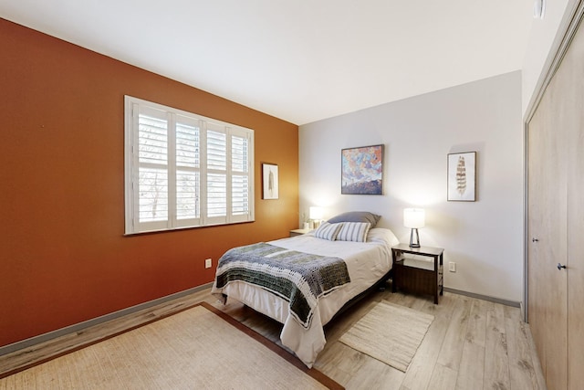 bedroom featuring light wood-type flooring and a closet