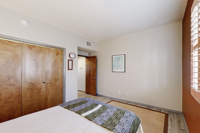 bedroom featuring a closet and light wood-type flooring