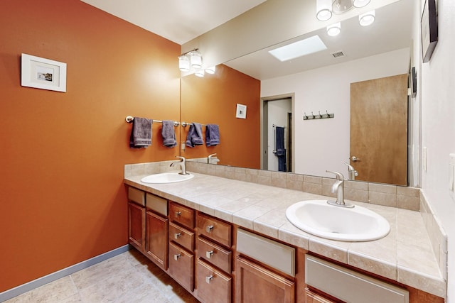 bathroom with vanity and a skylight