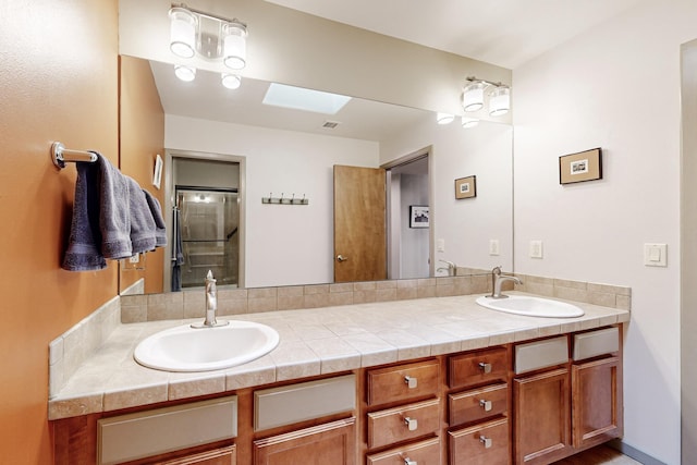 bathroom featuring a skylight and vanity