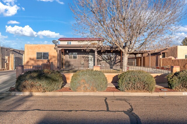 view of front of property featuring a front lawn and a carport