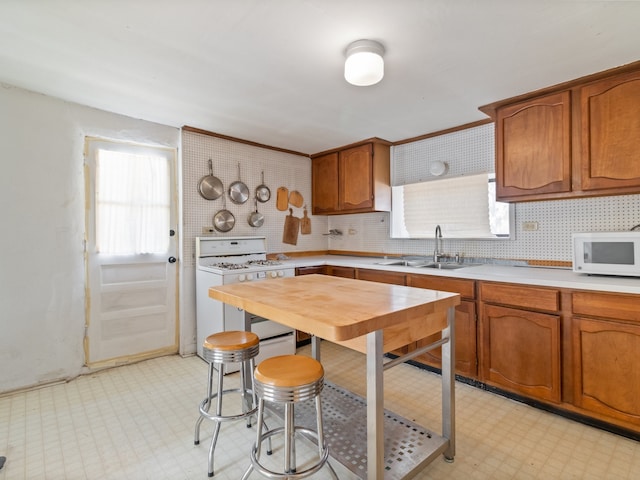 kitchen with sink, white appliances, and tasteful backsplash