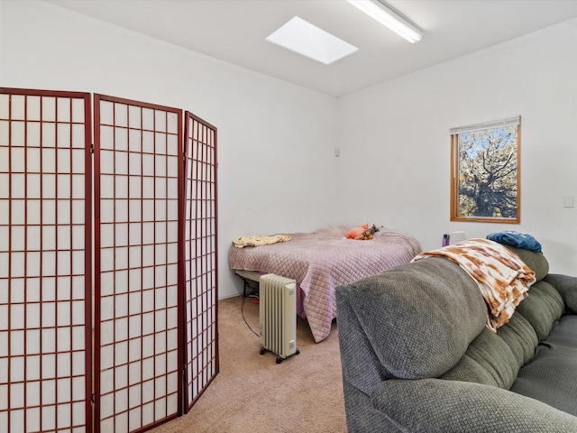 bedroom featuring a skylight and carpet flooring
