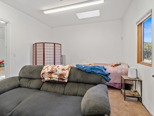 bedroom featuring a skylight and carpet flooring