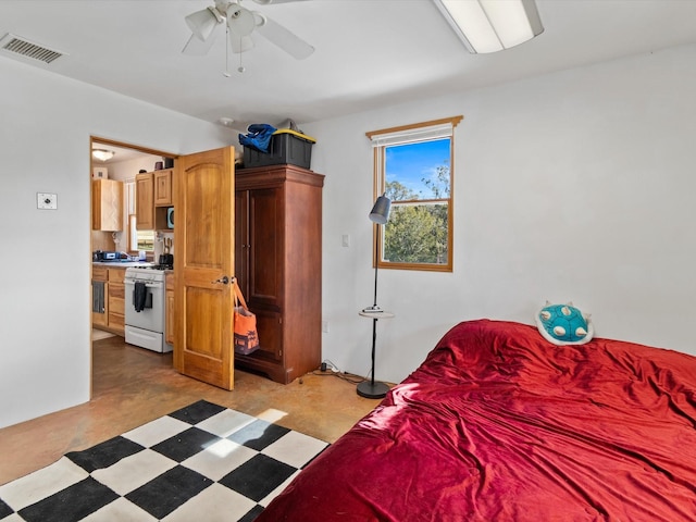 bedroom with tile patterned floors, visible vents, and a ceiling fan