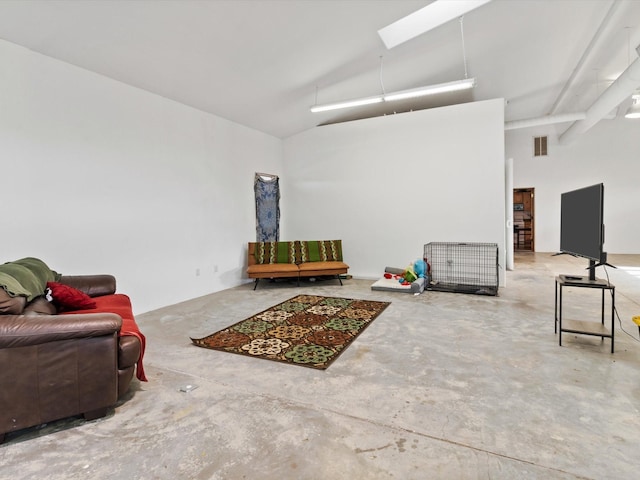 sitting room with visible vents, high vaulted ceiling, and concrete flooring