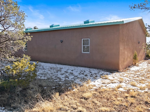 view of side of home featuring metal roof