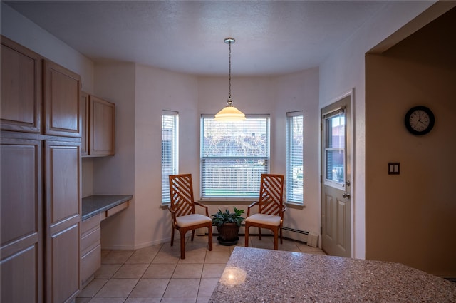 sitting room featuring light tile patterned flooring and built in desk