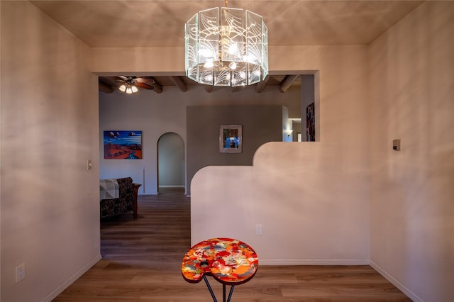 hallway featuring a chandelier, beam ceiling, and hardwood / wood-style flooring