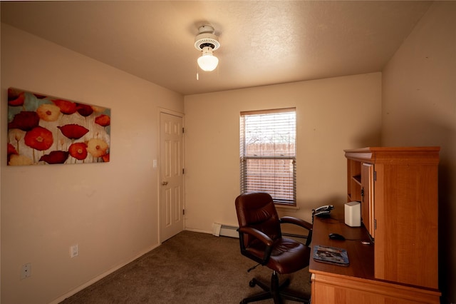 office space with a baseboard heating unit and dark colored carpet