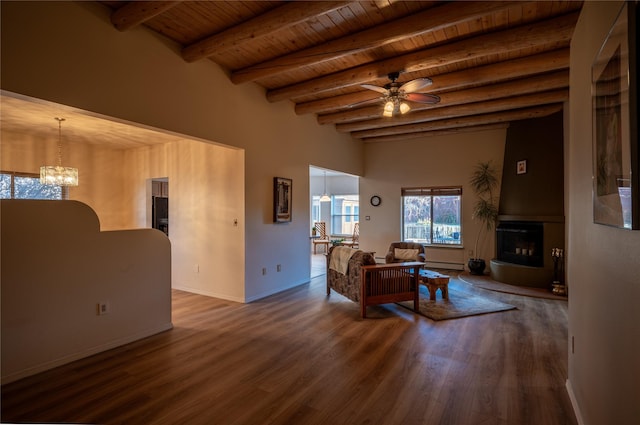 living room featuring a baseboard heating unit, wooden ceiling, ceiling fan with notable chandelier, dark wood-type flooring, and beam ceiling