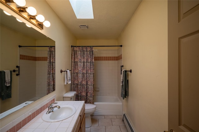 full bathroom featuring baseboard heating, tile patterned floors, vanity, a skylight, and toilet