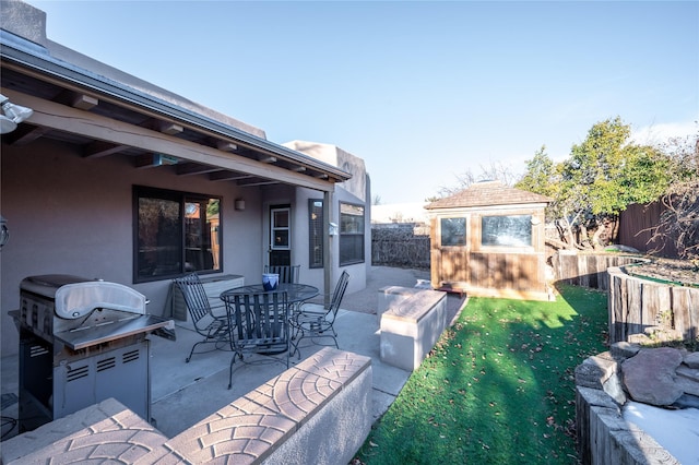 view of patio / terrace featuring grilling area and an outdoor structure