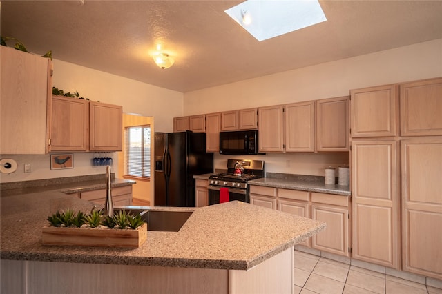 kitchen with kitchen peninsula, light brown cabinets, black appliances, and a skylight