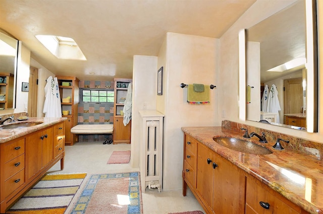 bathroom featuring a skylight and vanity