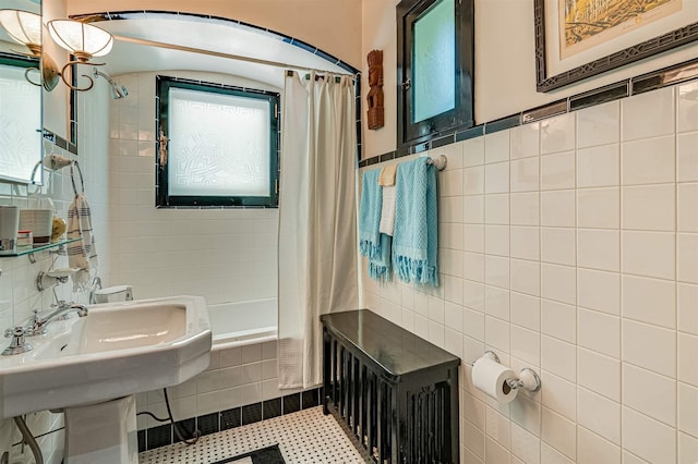 bathroom featuring tile walls, plenty of natural light, and shower / bath combo