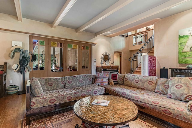 living room featuring beam ceiling and hardwood / wood-style floors