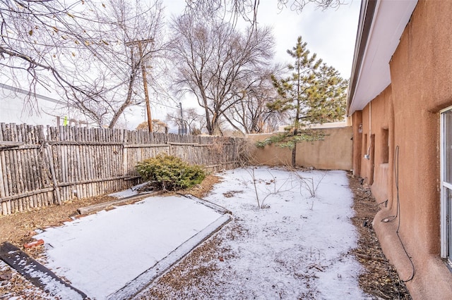 view of yard layered in snow