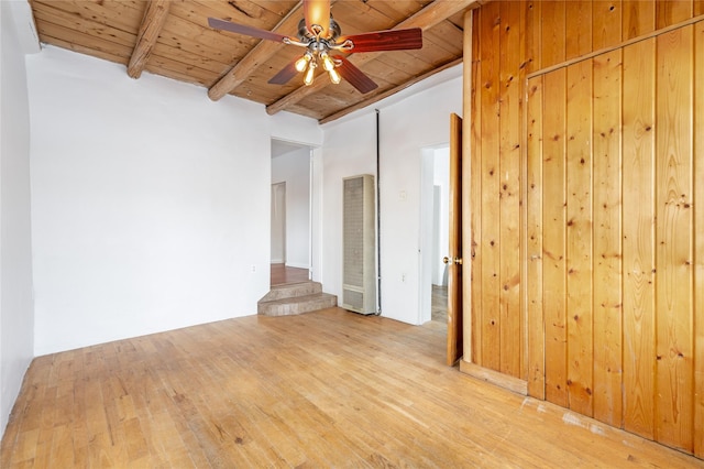 unfurnished room with ceiling fan, wood ceiling, light hardwood / wood-style flooring, and beamed ceiling