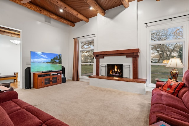 living room featuring light carpet, wood ceiling, a high ceiling, and beamed ceiling