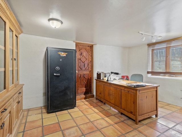 kitchen featuring rail lighting, a peninsula, and light tile patterned floors