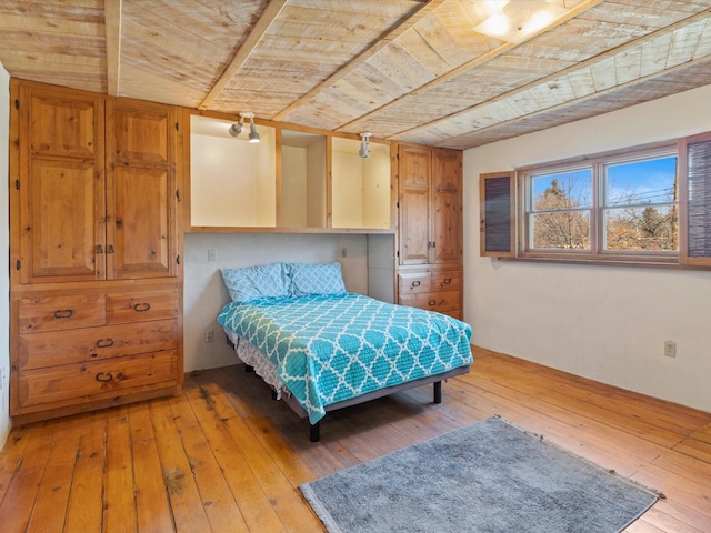 bedroom featuring wood ceiling and light wood finished floors