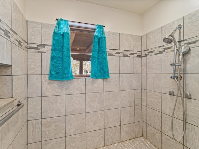 bathroom with a tile shower