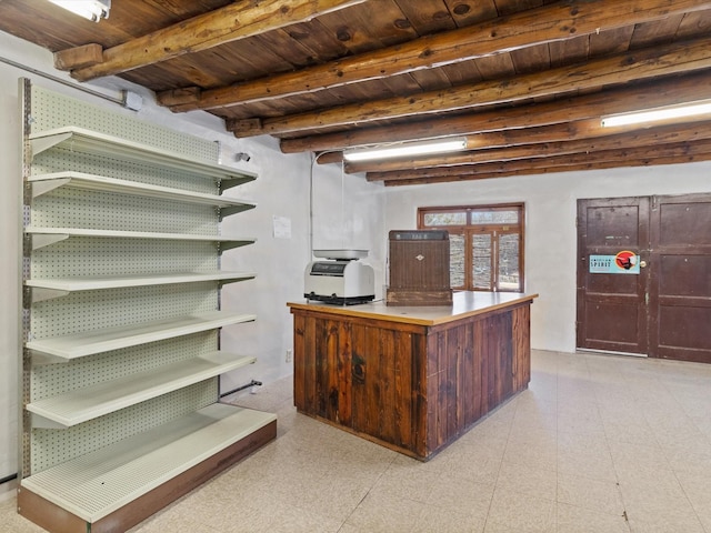 office with beamed ceiling, light floors, and wood ceiling