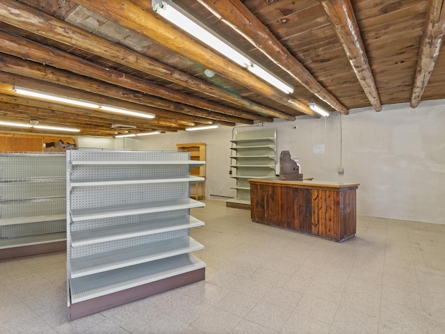 finished below grade area featuring wooden ceiling and tile patterned floors