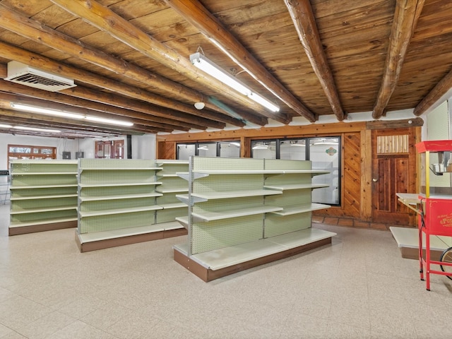 basement with tile patterned floors, wooden walls, wood ceiling, and visible vents