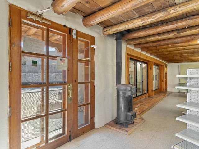 below grade area with tile patterned floors, a wood stove, and wood ceiling