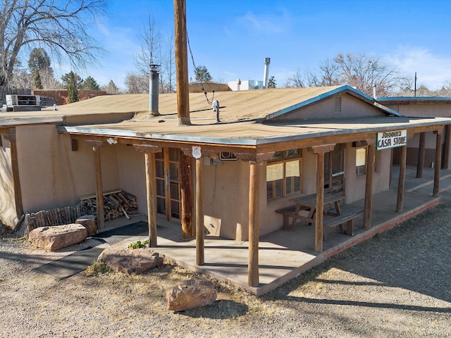 back of property with a patio