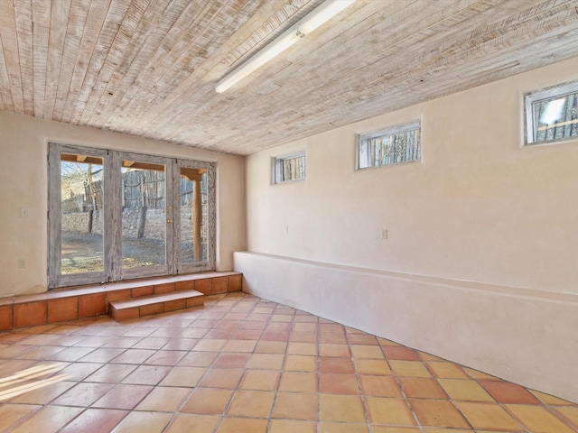 interior space with tile patterned floors and wood ceiling