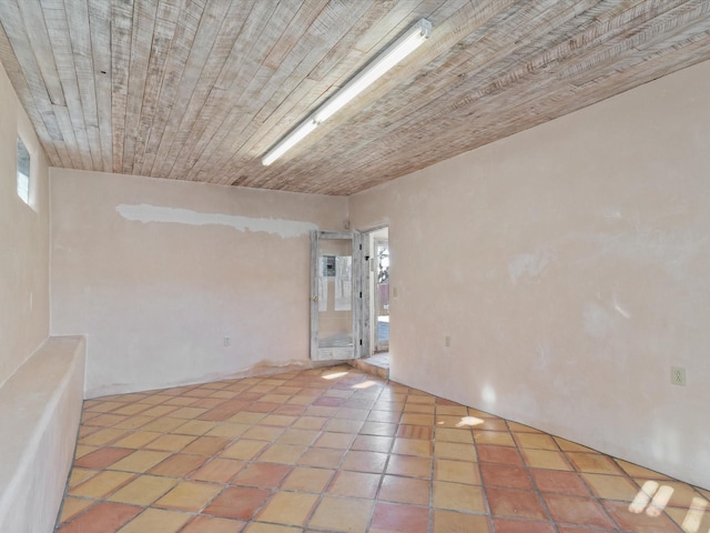 unfurnished room featuring tile patterned floors and wood ceiling