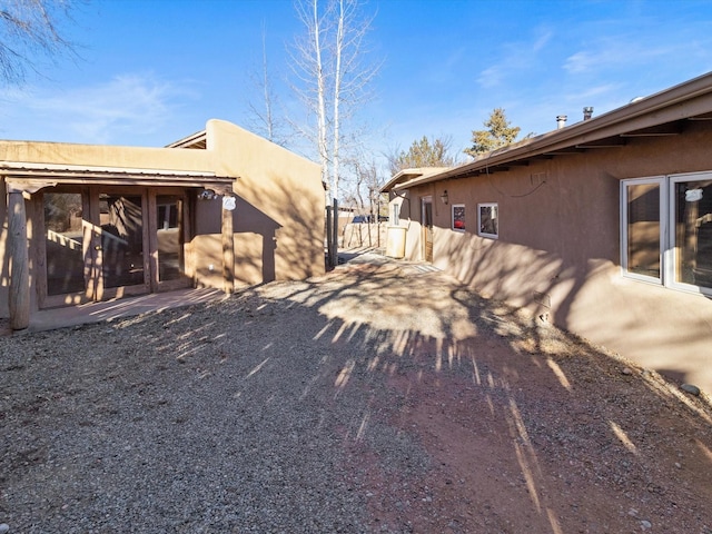 view of home's exterior featuring fence and stucco siding