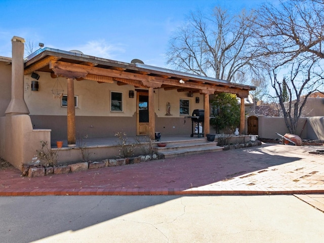 pueblo revival-style home featuring stucco siding