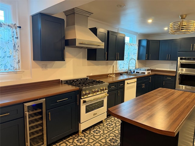 kitchen featuring dishwasher, butcher block countertops, beverage cooler, custom range hood, and range with gas stovetop