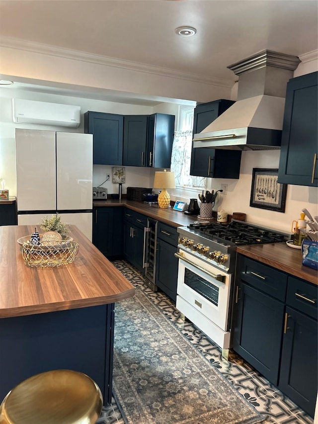 kitchen with wall chimney exhaust hood, high end white range, butcher block counters, refrigerator, and a wall mounted AC