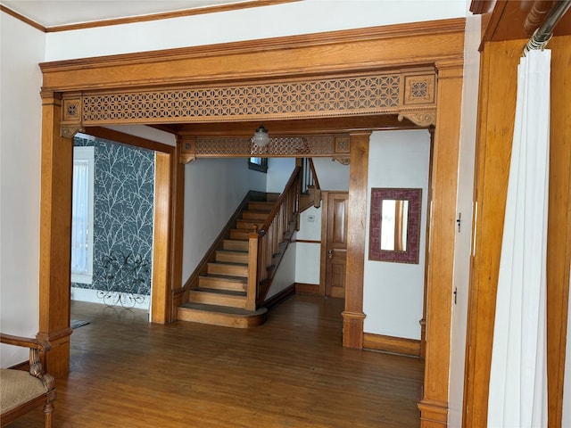 interior space featuring dark wood-type flooring and crown molding