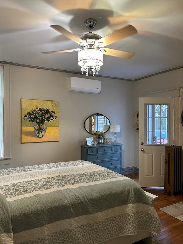 bedroom featuring ceiling fan, dark hardwood / wood-style flooring, crown molding, and a wall mounted air conditioner