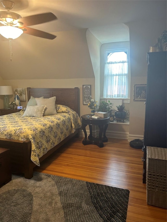 bedroom featuring ceiling fan, vaulted ceiling, and hardwood / wood-style flooring