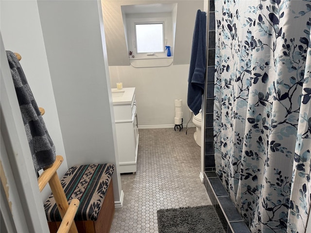 bathroom with toilet, vanity, tile patterned floors, and walk in shower