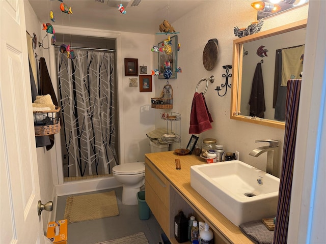 bathroom with toilet, vanity, and walk in shower