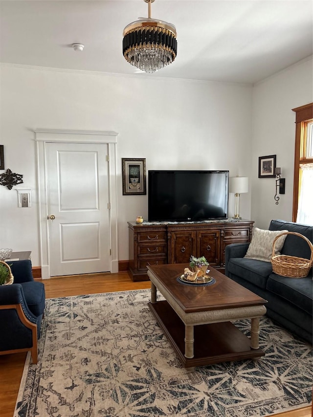 living room with an inviting chandelier and light wood-type flooring