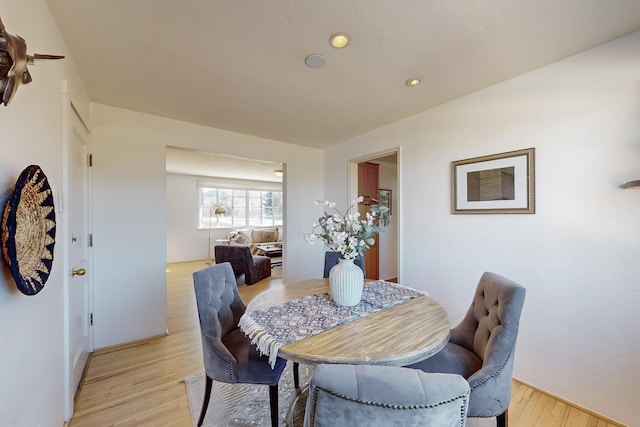 dining space with light hardwood / wood-style flooring