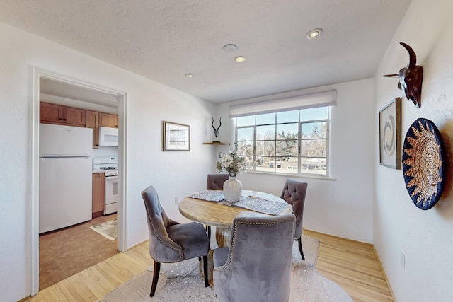 dining space with light wood-type flooring